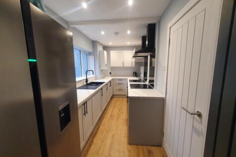 This modern kitchen features sleek cabinetry an...