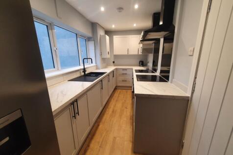 Modern kitchen featuring sleek cabinetry, ample...