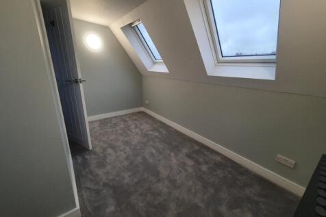 Spacious double bedroom featuring large windows...