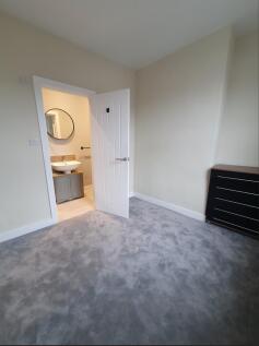 Spacious double bedroom featuring plush carpeti...