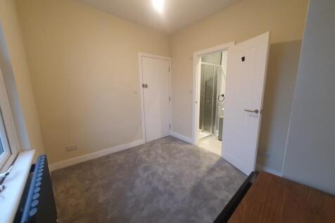 This inviting double bedroom features a cozy at...