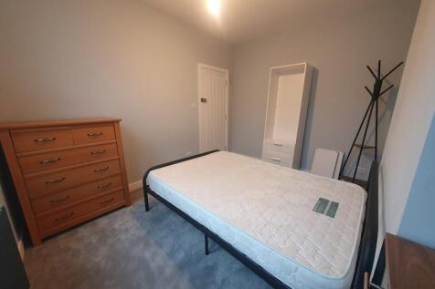 A well-proportioned double bedroom featuring a ...