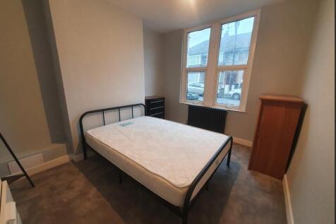 This inviting double bedroom features large win...