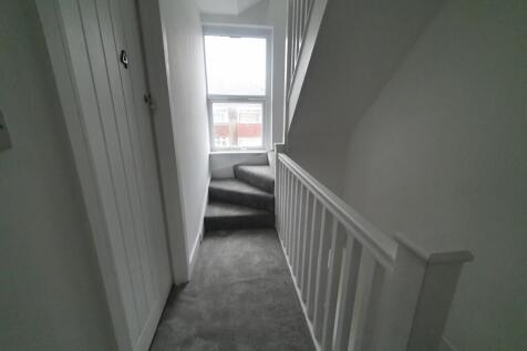 A well-maintained staircase leading to the uppe...