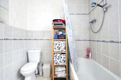A tidy and bright bathroom featuring a shower a...