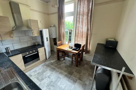 A spacious and well-lit kitchenette with modern...