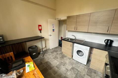 A spacious and modern kitchenette, equipped wit...