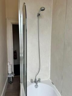 A well-maintained bathroom featuring a shower, ...