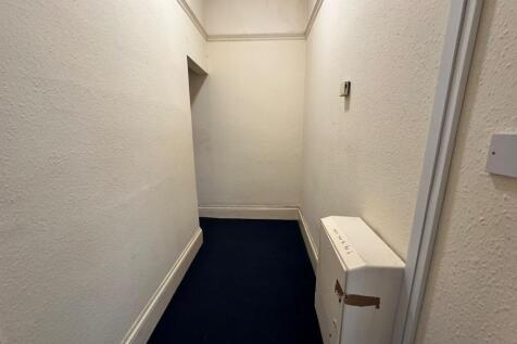 A tidy hallway with potential for welcoming gue...