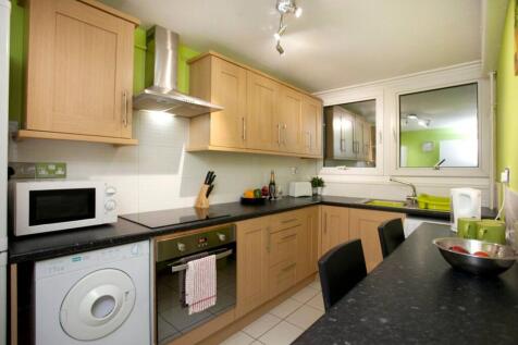 A modern and tidy kitchenette with ample storag...