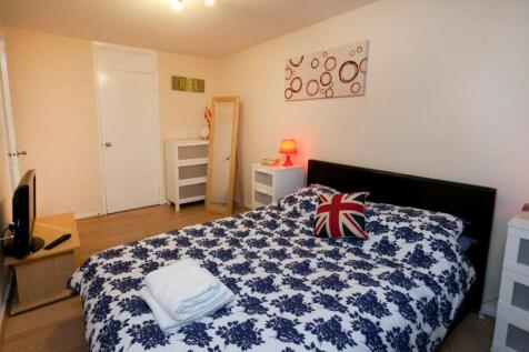 A bright and inviting double bedroom with styli...
