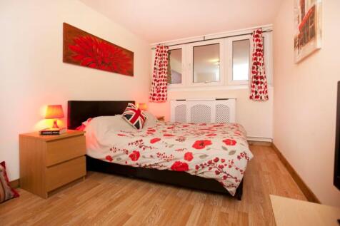 A vibrant and cozy double bedroom featuring bri...