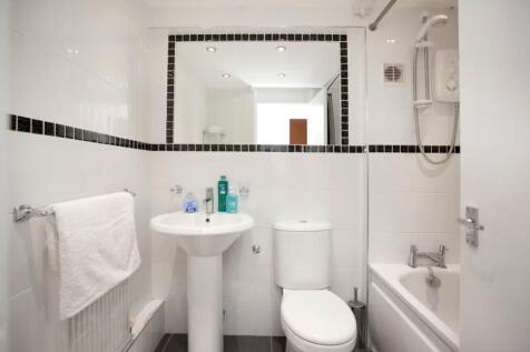 A modern and clean bathroom featuring a bath an...