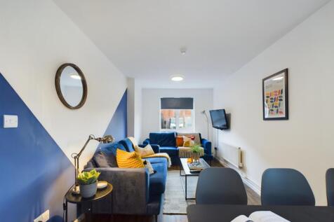 A spacious and stylish living room with modern ...