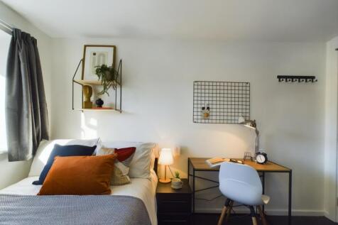 A bright and stylish double bedroom featuring m...