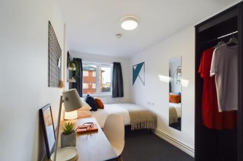 A bright and stylish double bedroom featuring a...