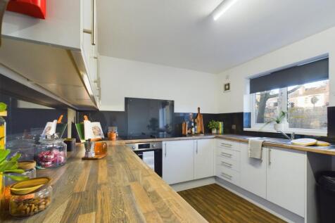 A bright and modern kitchen with ample counter ...