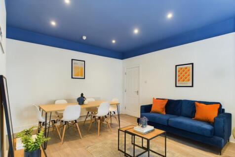 A spacious and modern living room, ideal for so...