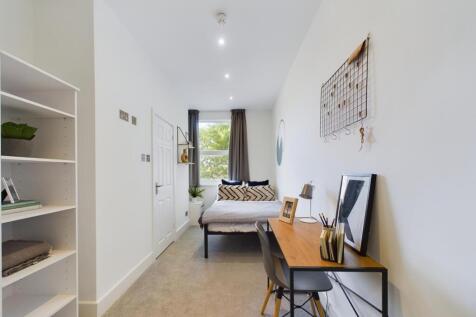 A bright and inviting double bedroom featuring ...