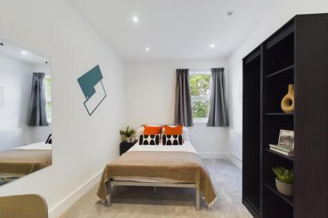 A stylish and modern double bedroom with ample ...