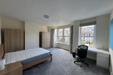 Bright and spacious master bedroom featuring a ...