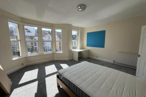Bright and spacious master bedroom with a large...