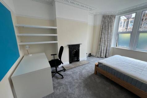 A spacious and inviting double bedroom featurin...