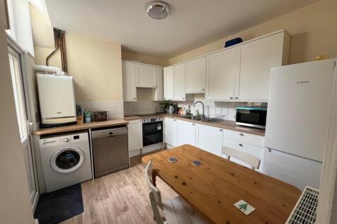 A bright and tidy kitchen featuring modern appl...