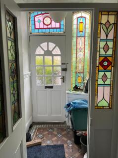 A charming hallway with stained glass windows t...