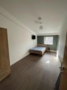 A spacious and bright double bedroom with moder...