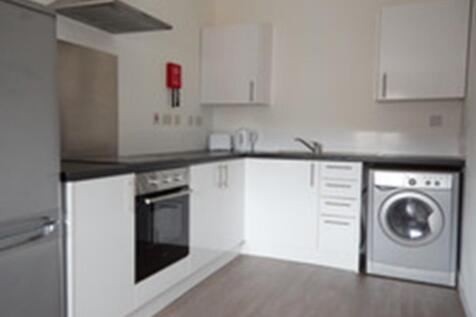 A modern and tidy kitchenette with ample storag...