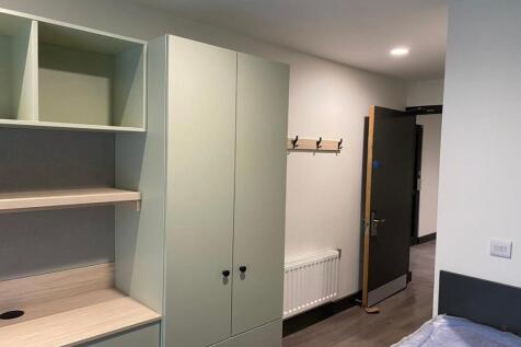 A modern double bedroom featuring stylish stora...
