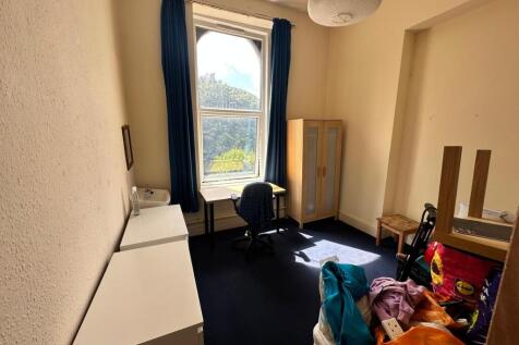 A bright and spacious double bedroom with ample...