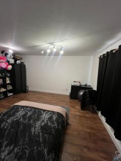 A spacious and inviting double bedroom featurin...