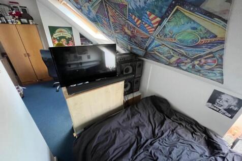 A cozy double bedroom featuring vibrant decor a...