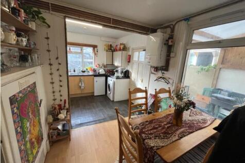 A cozy kitchenette with ample natural light, pe...
