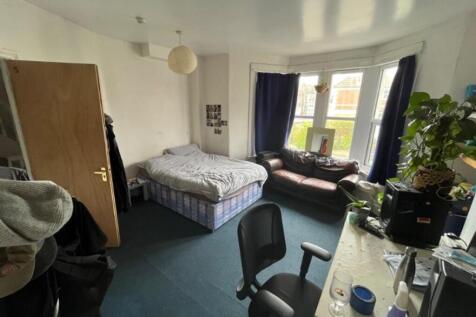 A cozy double bedroom with ample natural light ...