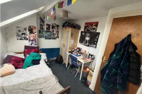A cozy double bedroom filled with character, pe...