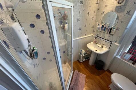 A bright and tidy bathroom featuring a modern s...