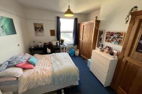 A cozy and inviting double bedroom with ample s...