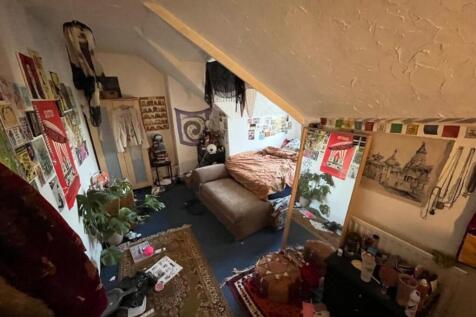 A cozy double bedroom filled with character, pe...