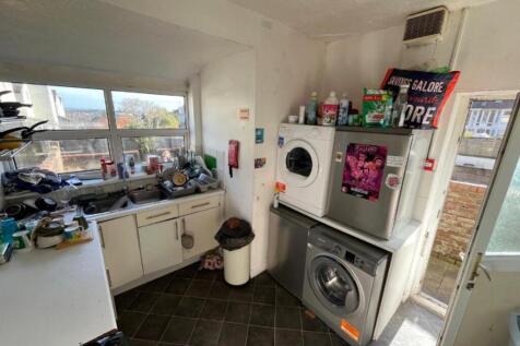 A compact kitchenette with ample natural light ...
