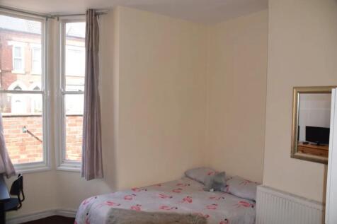 A bright and inviting double bedroom featuring ...