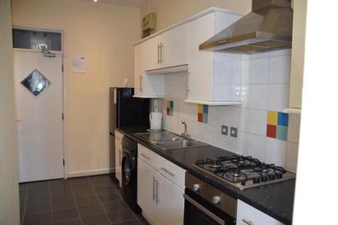 A modern and tidy kitchenette with ample storag...
