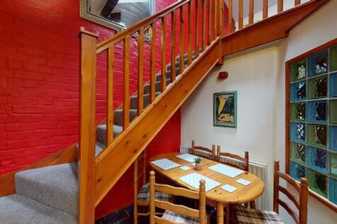 A charming staircase leading to an inviting upp...