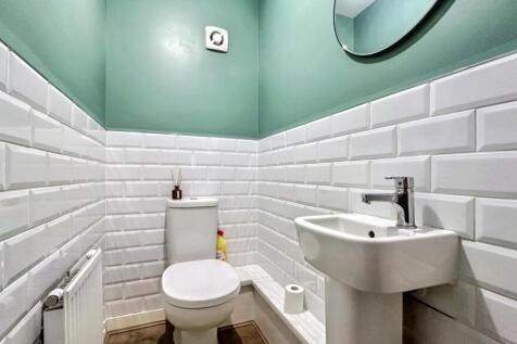 A modern and stylish single toilet with a fresh...