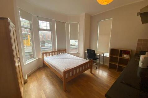 A spacious and bright double bedroom, featuring...