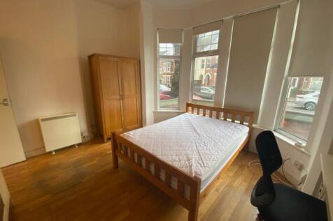 A bright and spacious double bedroom featuring ...