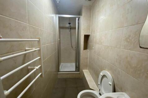 A functional bathroom featuring a shower and mo...