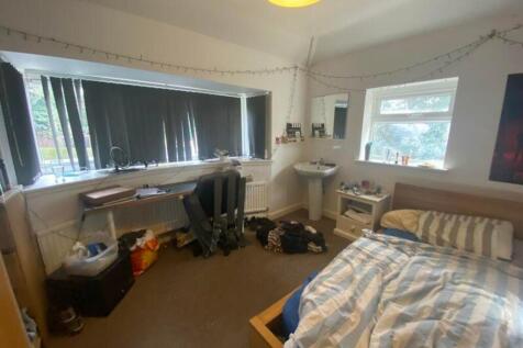A spacious double bedroom with ample natural li...